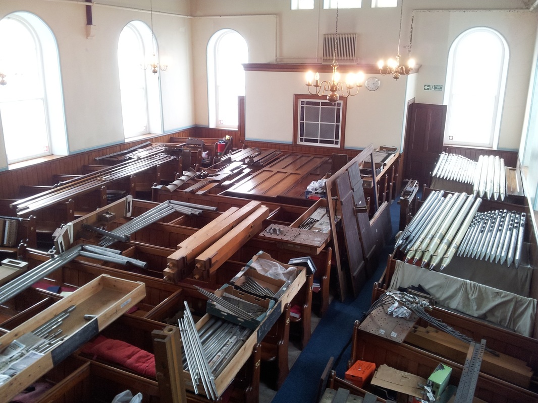 Organ pipes stored on the pew tops in Bethany Chapel