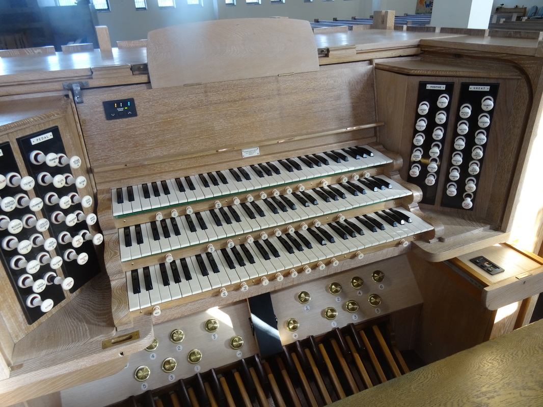 The refurbished console of the Cousins organ.